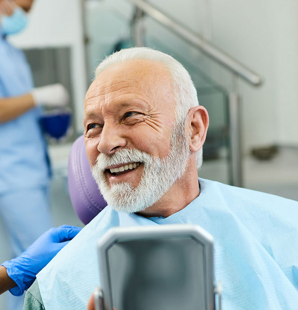 patient with mirror happy with implant results mobile